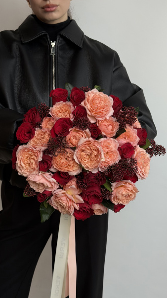Букет з персикових піоноподібних та червоних троянд зі скімією